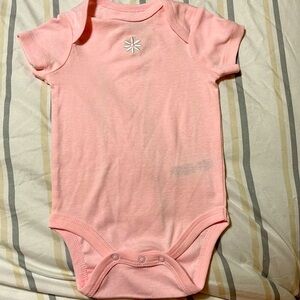 Little Me Pink Onesie with snaps has small flower on the chest.